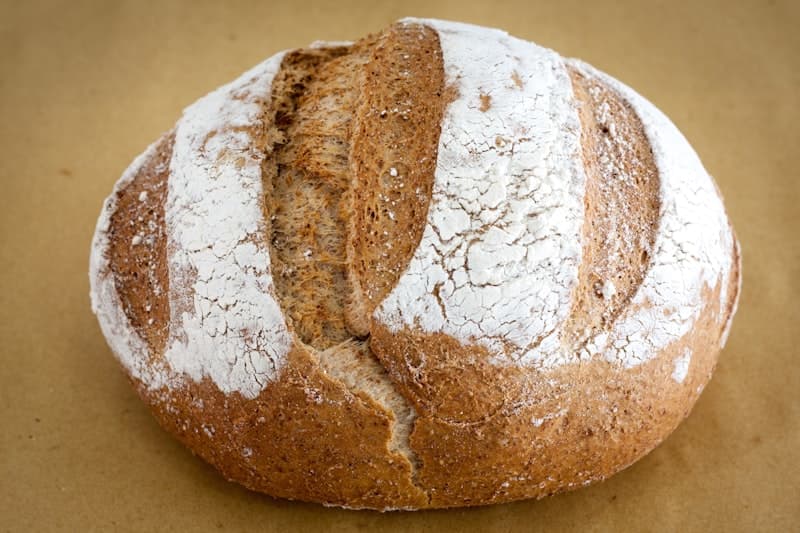 Olive & Rosemary Sourdough — Kalamata olives and woody rosemary from our Crystal Palace garden, folded through a white sourdough base. The olives blister in the oven and leave pockets of salt and oil throughout.